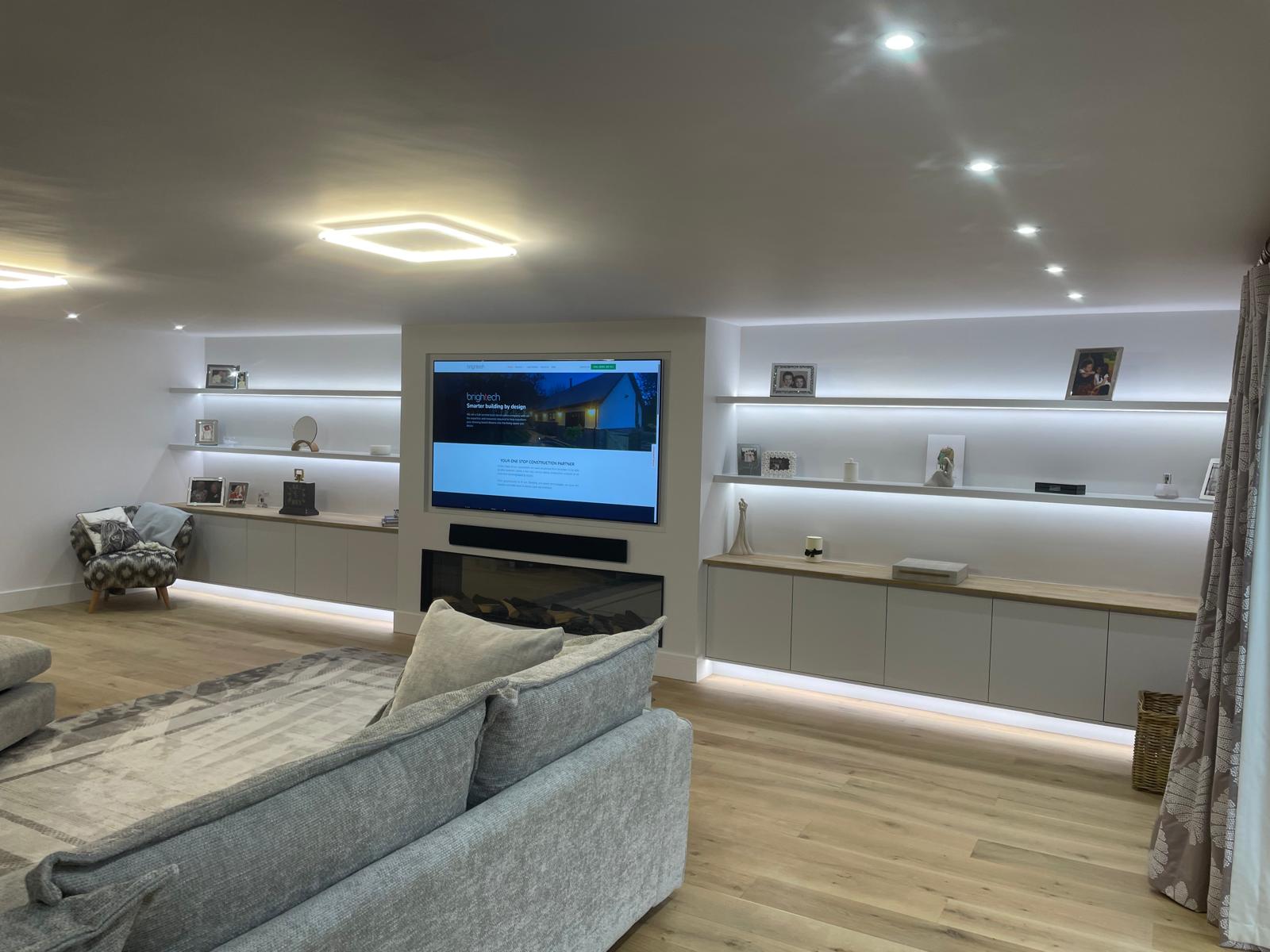 Living space with integrated lighting, wall-mounted television and concealed cabling