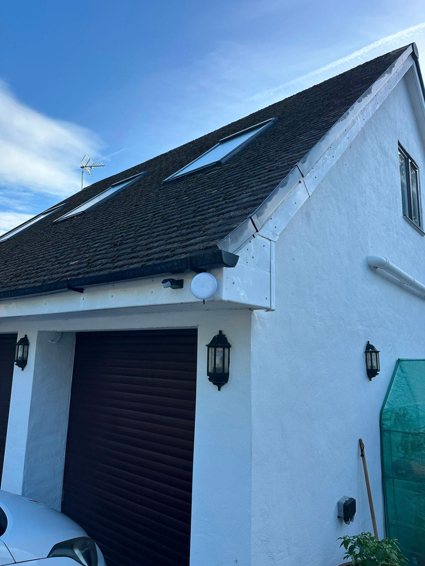 Wireless bridge mounted beneath the roofline above the garage